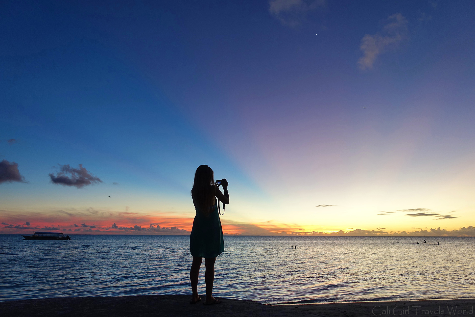 Cali Girl Travels World taking a photo on the main beach Matira on Bora Bora at Sunest.
