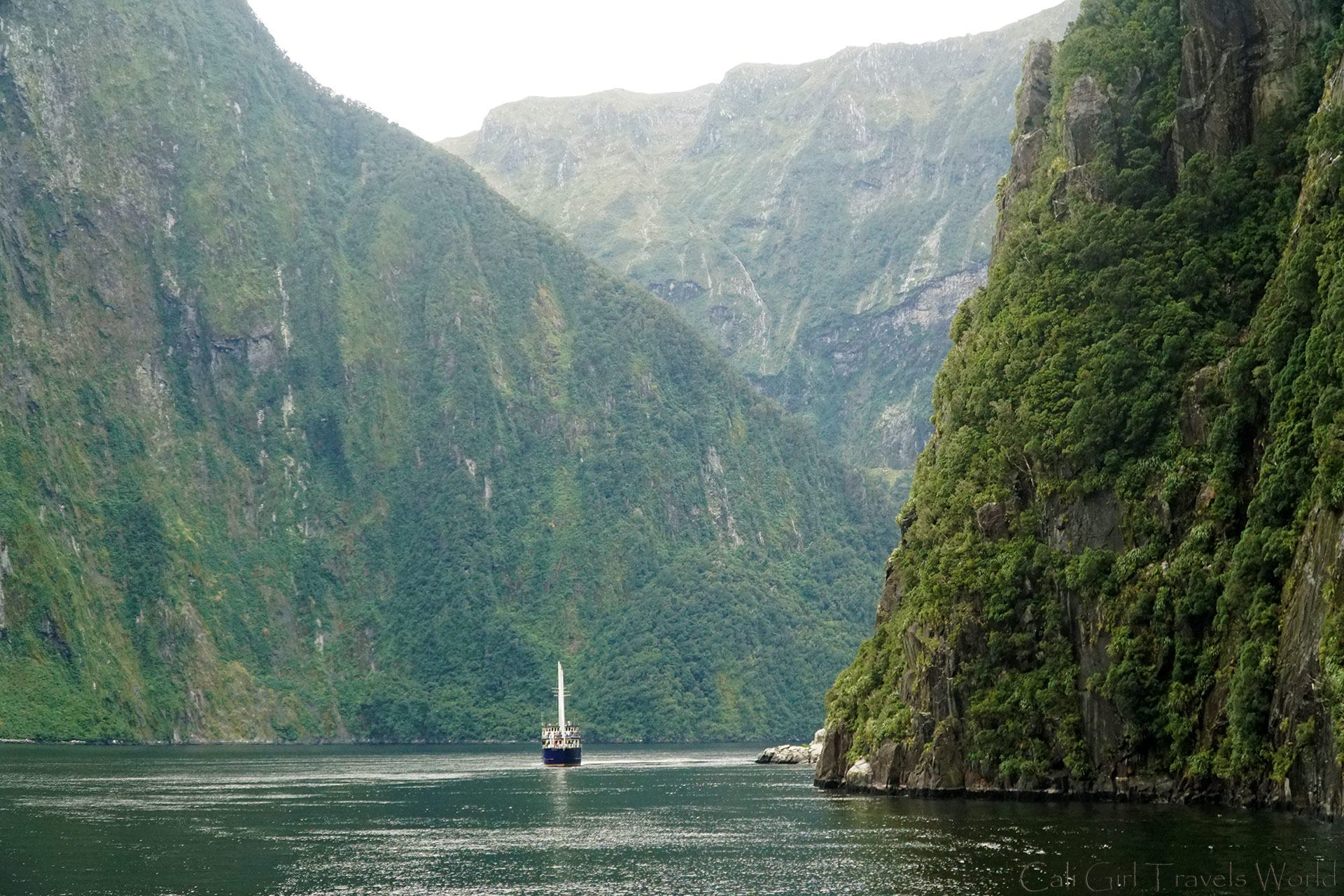Boat coasting along Milford Sound in South Island, New Zealand - stunning beauty.