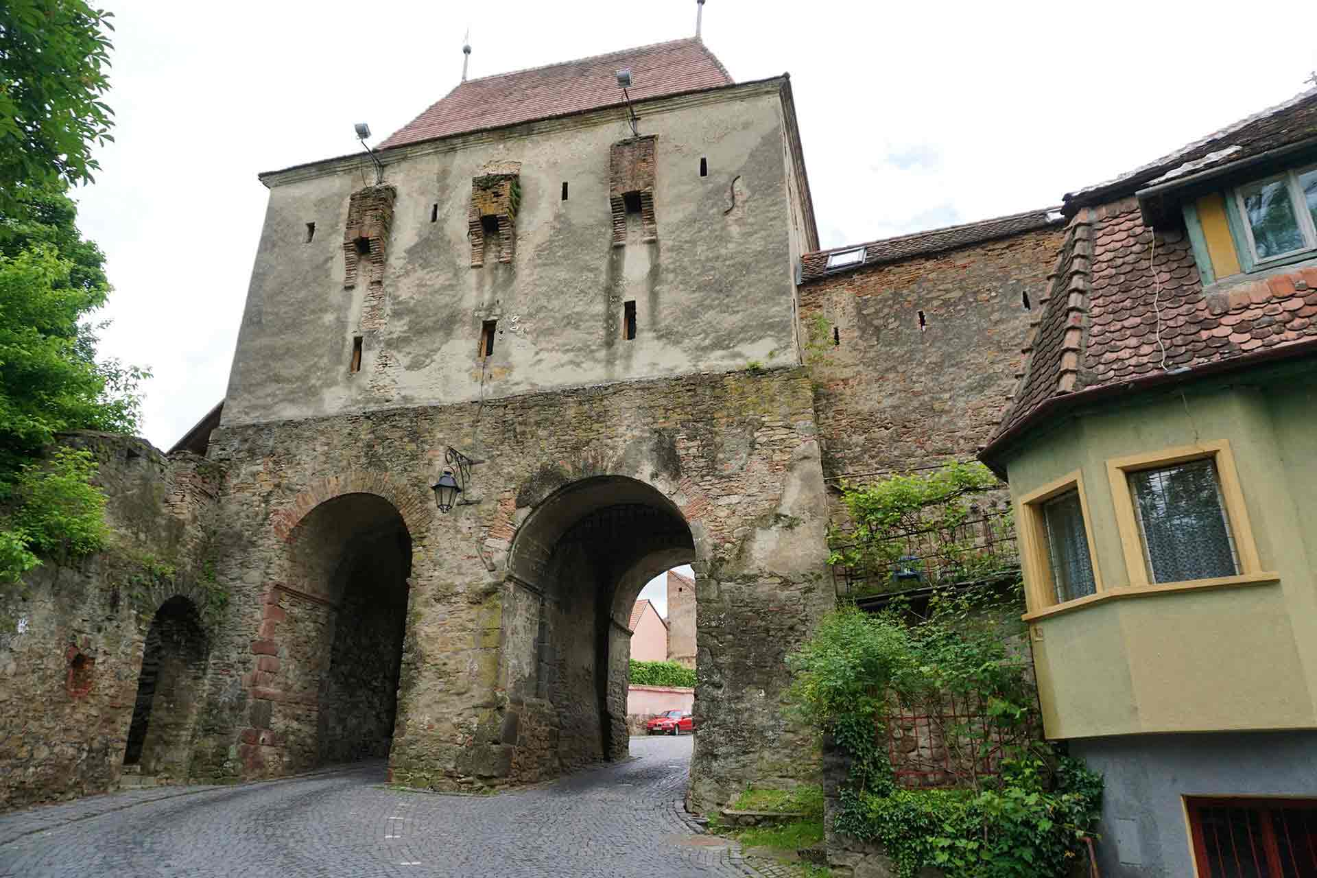 Entering the walled gateway of the citadel of Sighisoara, Transylvania, Romania.